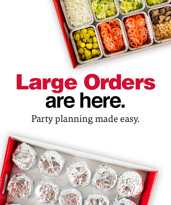 Top down image of Five Guys' large order program boxes, one filled with burgers wrapped in foil and the other featuring trays of toppings.